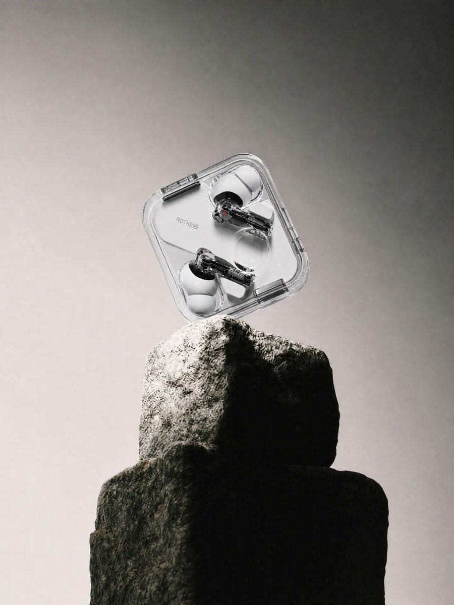 E-commerce Main Image - Transparent Earbuds on Stone Pedestal - Image 1